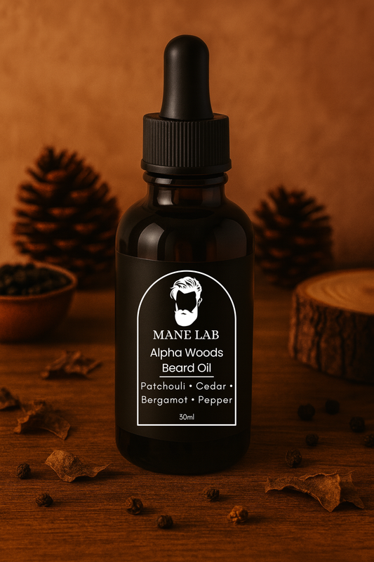 Bottle of Mane Lab Alpha Woods Beard Oil on a wooden surface with pine cones, peppercorns and wood slices in the background.